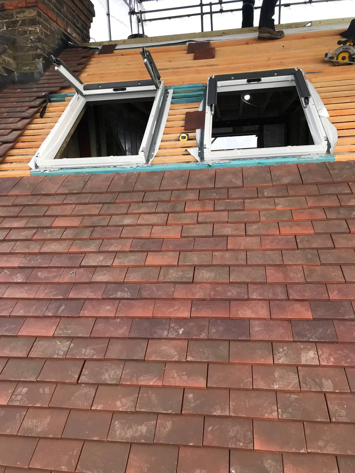 Clay tile roof with openings for roof windows