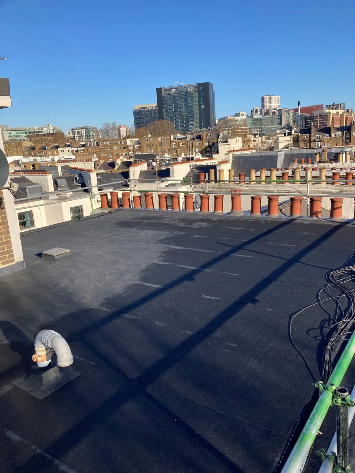 Flat roof above London with the skyline behind