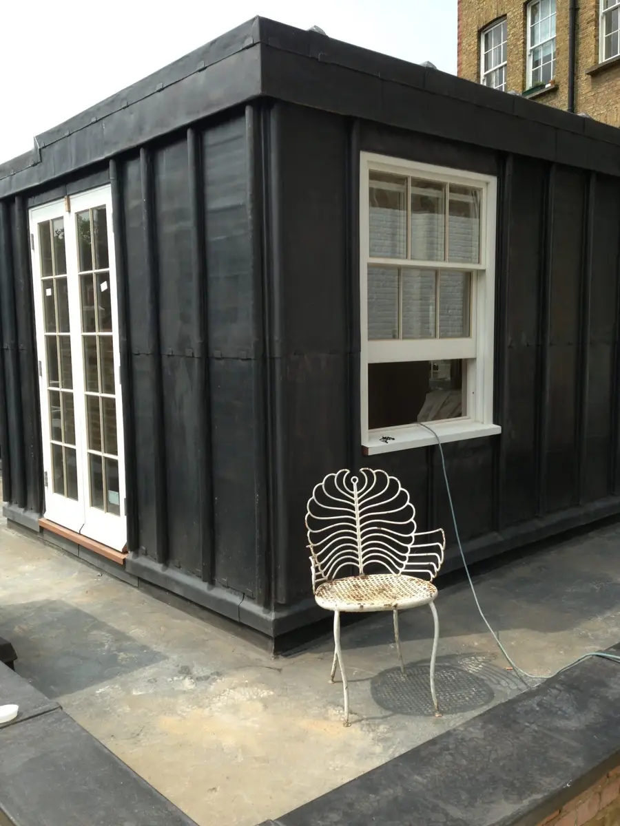 Dormer clad in dark lead on a roof terrace