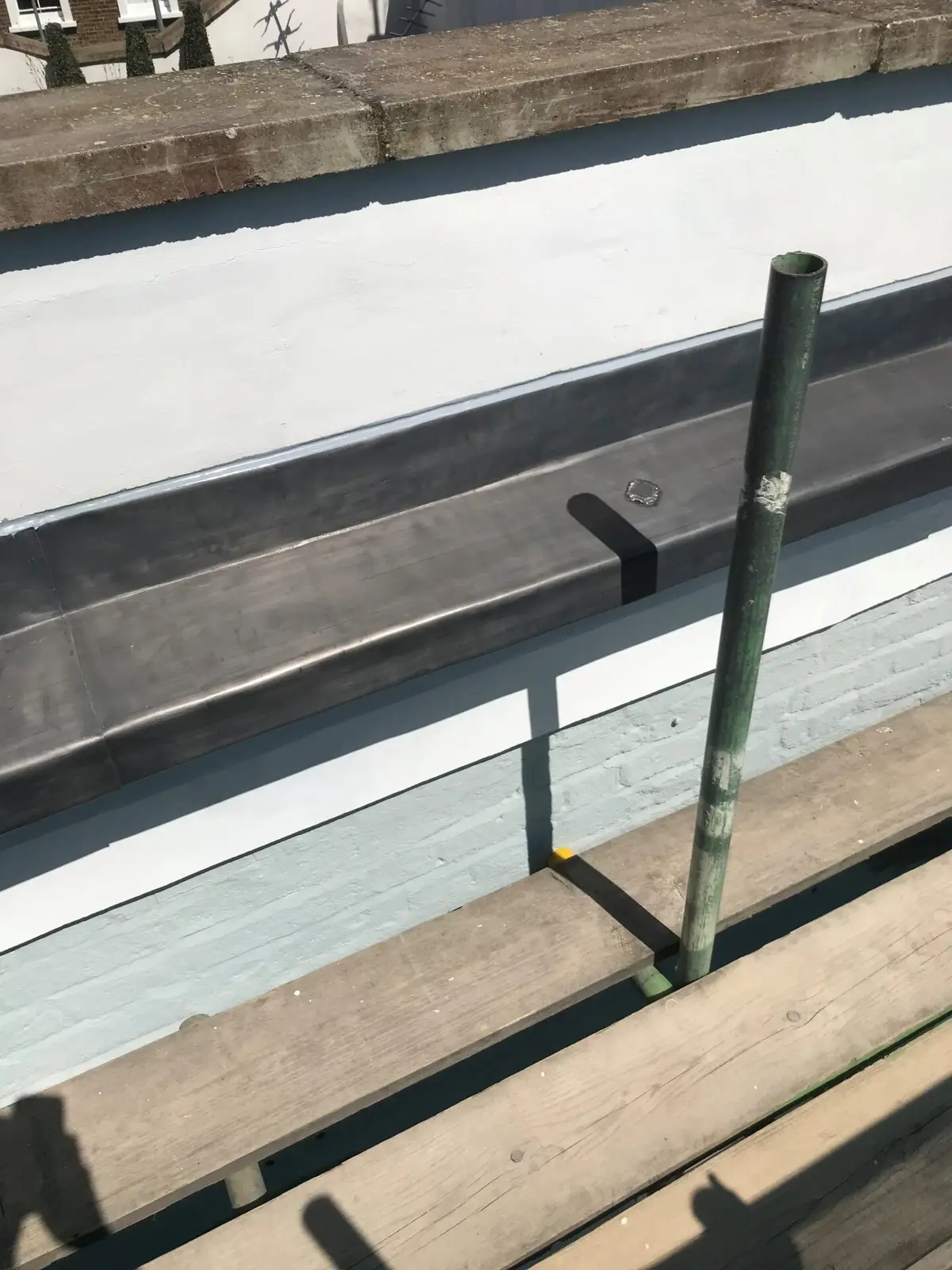 Lead gutter along a slate roof