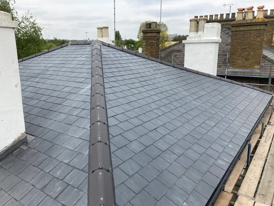 Finished slate roof and ridge between London chimney stacks