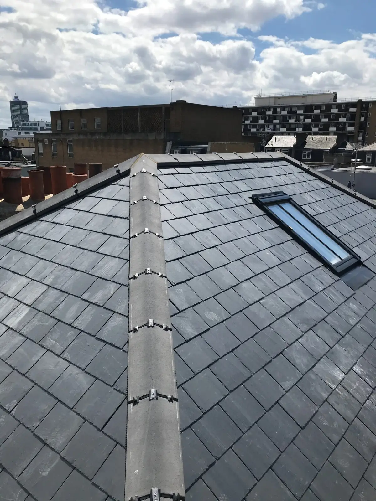 Slate roof with a new ridge and roof window