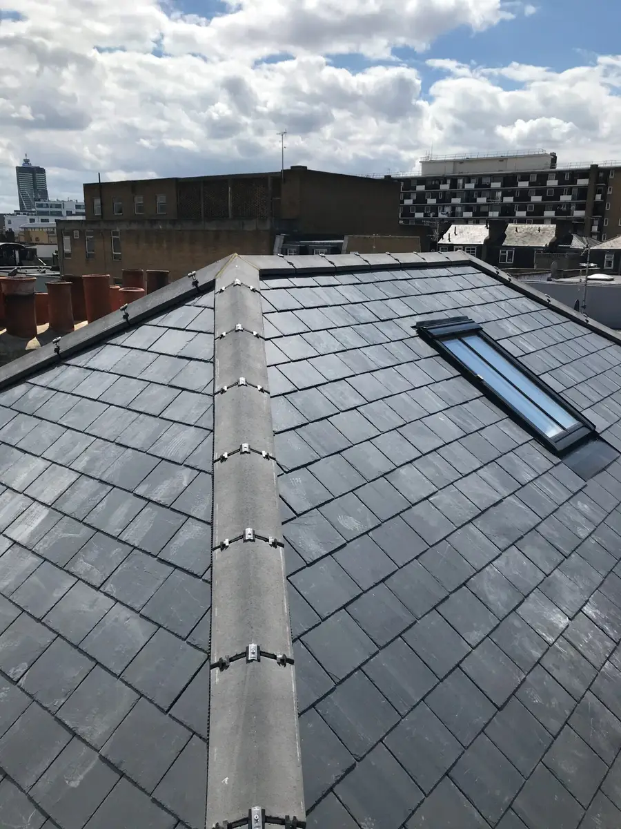 Slate roof with a roof window during the job