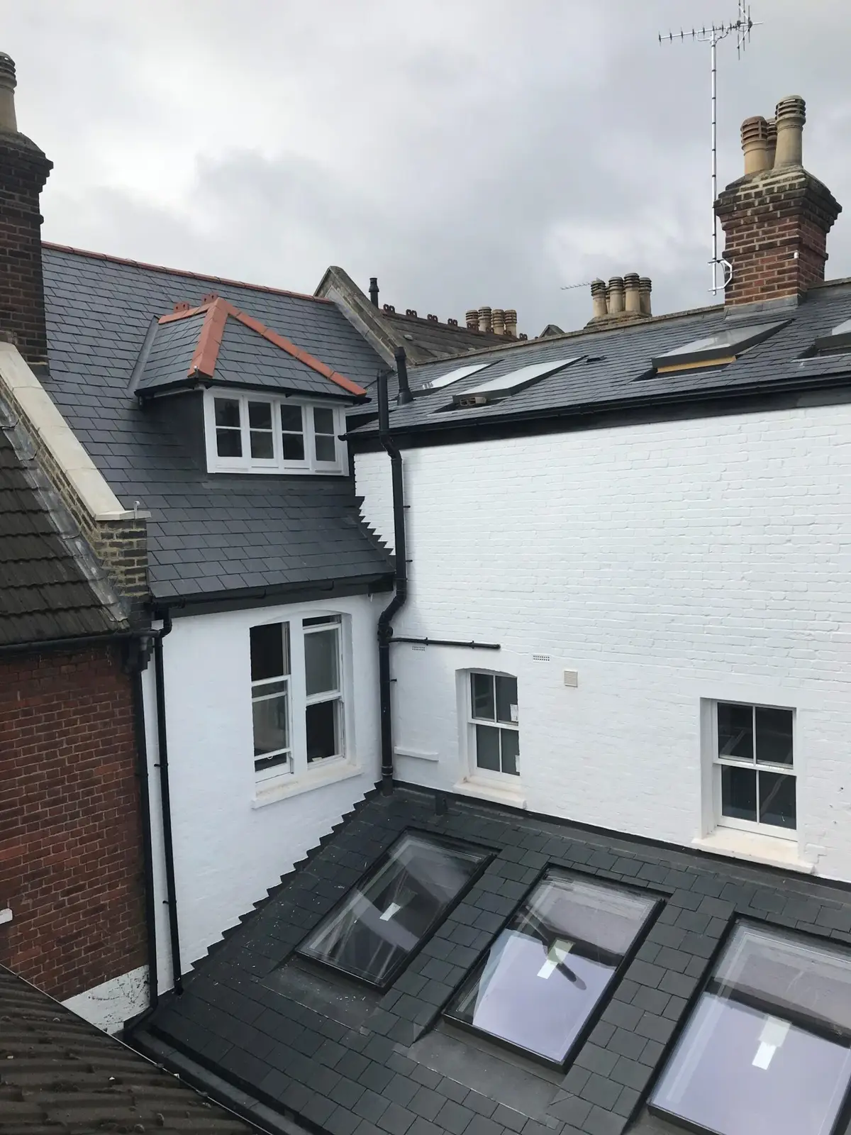 Slate roof and roof windows on a white terrace