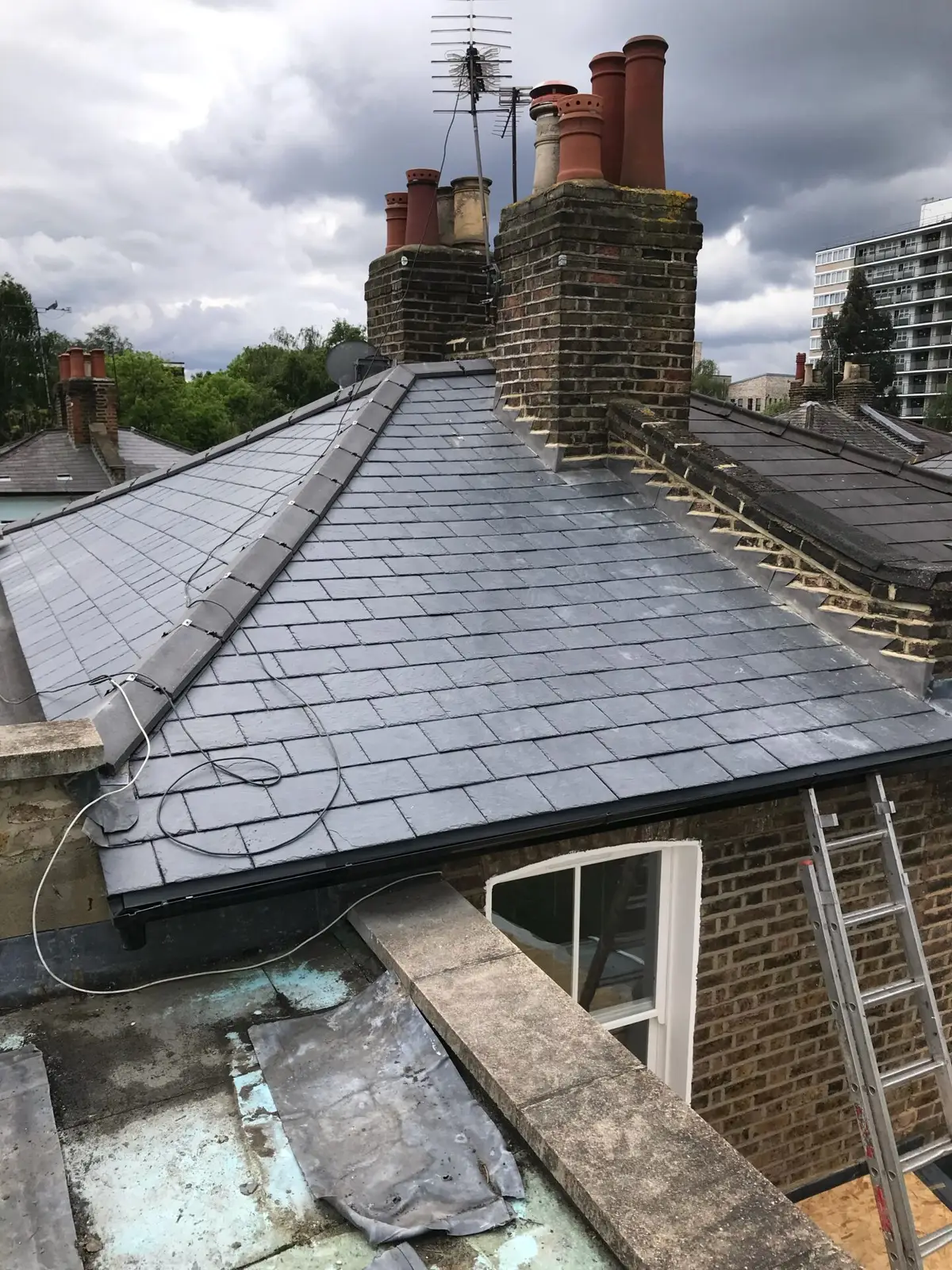 Slate roof with access ladder during the job
