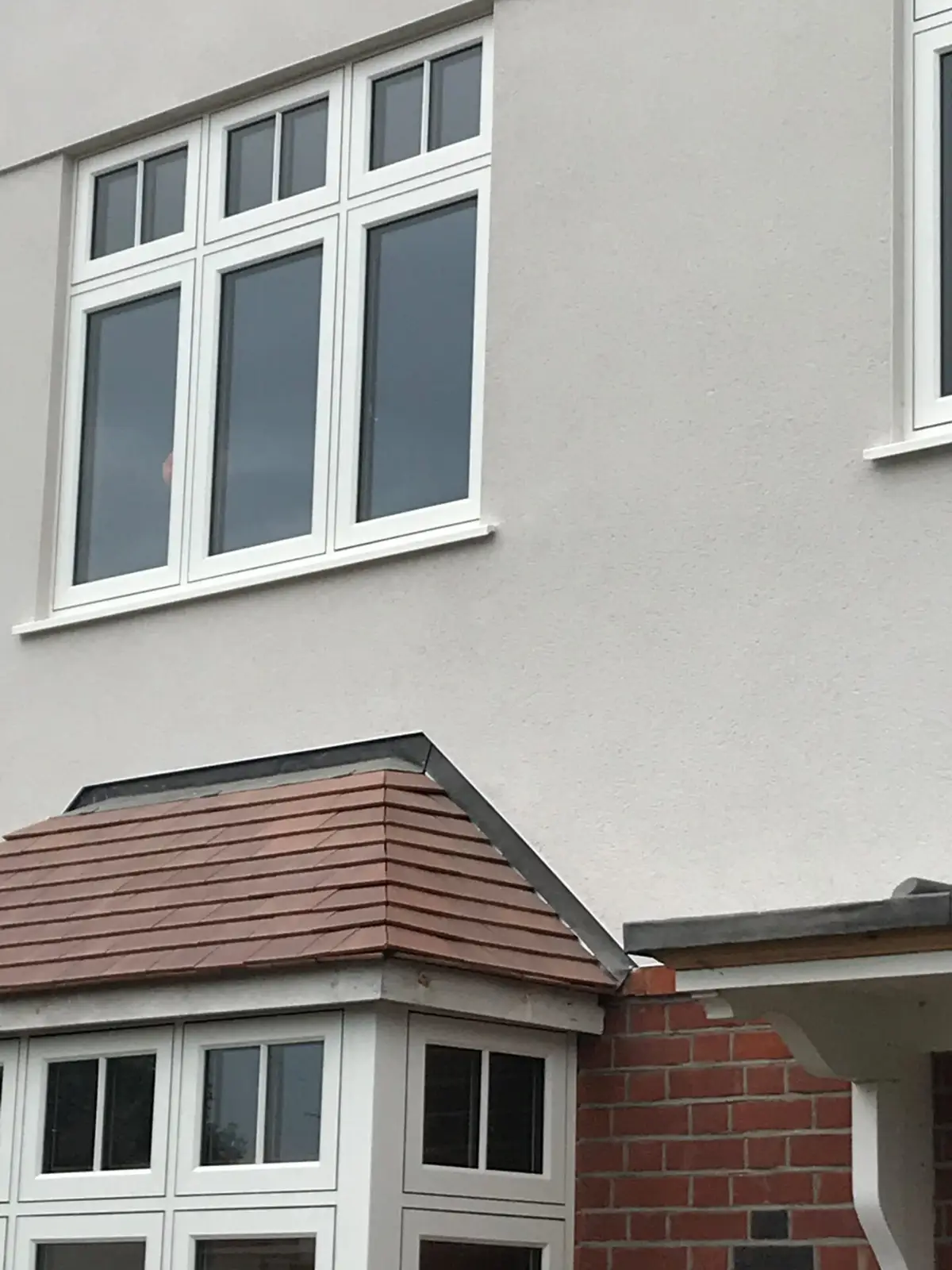 Tiled bay roof above bay windows