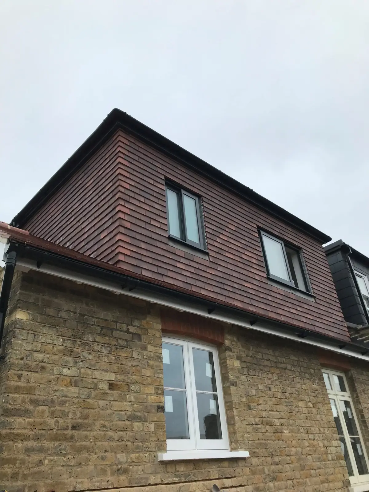 Tiled dormer on a brick house